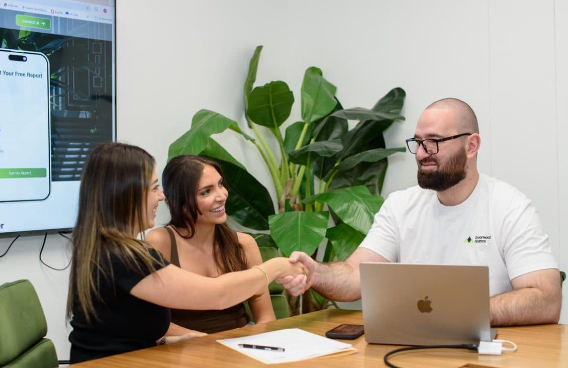 First home buyers happily reviewing options with their broker
