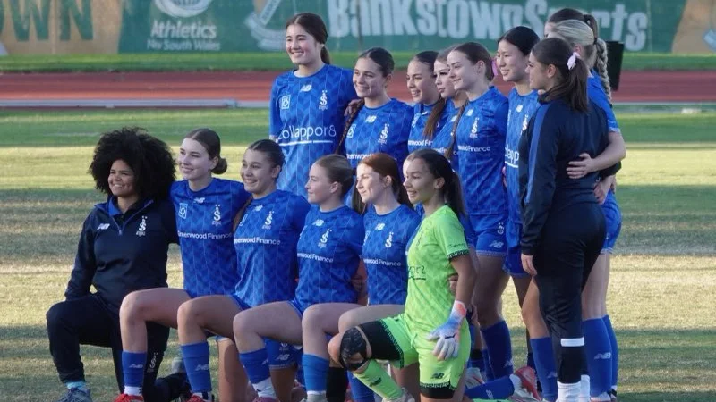 Sydney Olympic FC U18 Girls team lined up on the pitch in their blue home kit